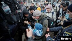 People board an evacuation train at Kyiv central train station amid Russia's invasion of Ukraine, March 7, 2022.
