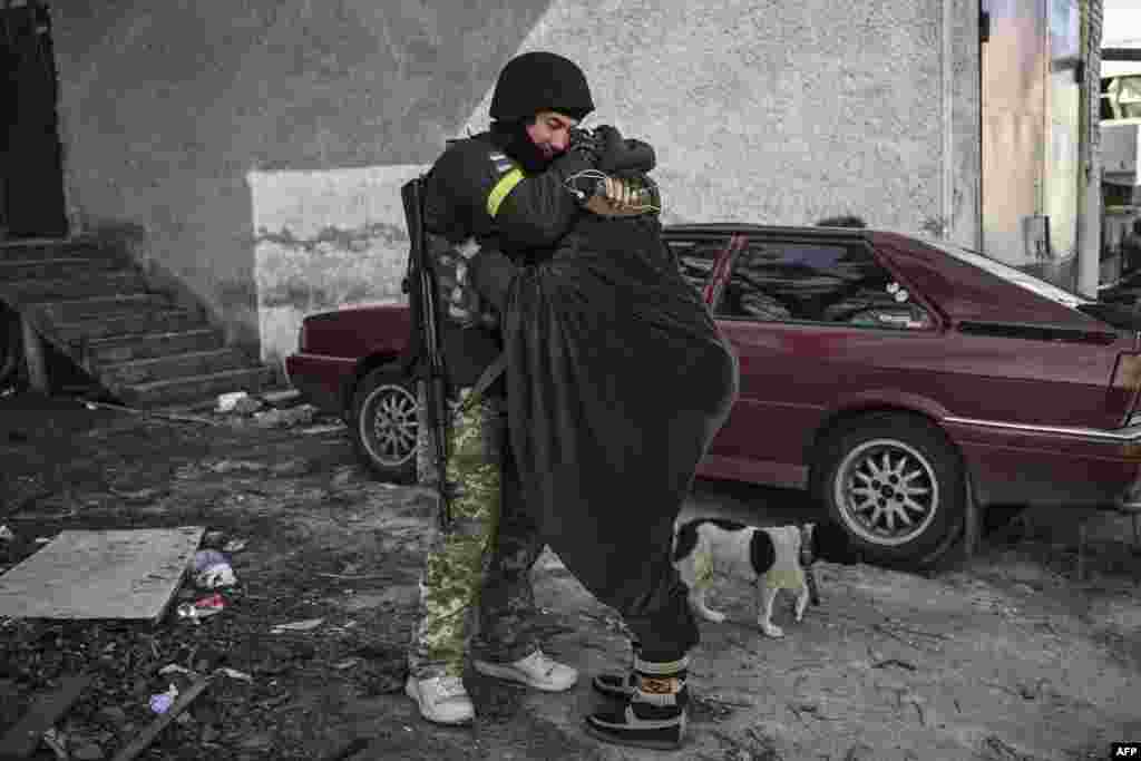 A Ukranian soldier hugs his wife in the city of Irpin, March 10, 2022.