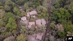 Homes are covered by volcanic ash spewed from the Volcano of Fire, in Panimache, Guatemala, March 8, 2022. 