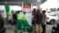 FILE - People queue at a petrol station in Lagos, Nigeria, Feb. 18, 2022. 