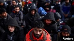 Foreign nationals fleeing Russia's invasion of Ukraine wait at the Shehyni border crossing to enter Poland, near Mostyska, Ukraine, March 1, 2022. 