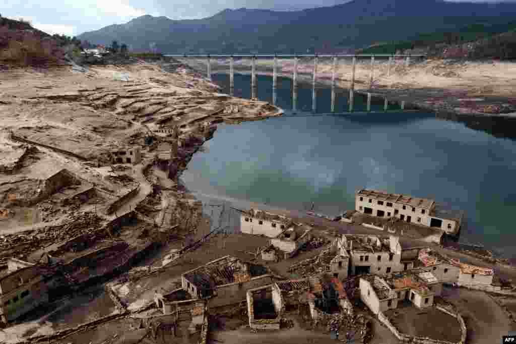 This photograph shows an aerial view of the usually submerged ruins of the former village of Aceredo, appearing from the Lindoso hydroelectric plant reservoir due to the low water level, near Lobios, Ourense province, northwestern Spain, Feb. 15, 2022.&nbsp;People living in the Aceredo village were evicted from their homes in 1992 for the construction of the reservoir.