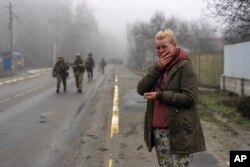 Mariya Ol'hovs'ka, 33, mourns the dead of her father Valerii Ol'hovs'kyi, 72, killed by a Russian missile on March 30 near his house in the outskirts of Kyiv, Ukraine, April 1, 2022.