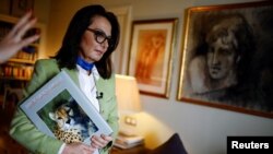 Tahrane Tahbaz, sister of detained Iranian-American environmentalist Morad Tahbaz, who also holds British citizenship, holds a book that her brother made, after talking with Reuters at her home in Madrid, Spain, March 18, 2022.