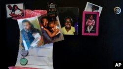 Family photos of Danielle Mitchell and Rodney Chiles and their daughter, Brooklynn Chiles, decorate the kitchen refrigerator in Washington, Feb. 9, 2022.