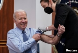 U.S. President Joe Biden receives a second coranavirus disease (COVID-19) booster vaccination after delivering remarks on COVID-19 in the Eisenhower Executive Office Building’s South Court Auditorium at the White House in Washington, U.S., March 30, 2022.