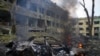 A car burns at the site of a maternity hospital damaged by shelling in Mariupol, Ukraine, March 9, 2022.