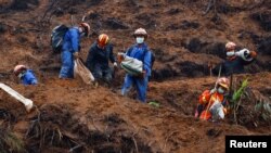 FILE - Rescue workers work at the site where a China Eastern Airlines Boeing 737-800 plane flying from Kunming to Guangzhou crashed, in Wuzhou, Guangxi Zhuang Autonomous Region, China, March 24, 2022. 