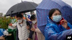 Relatives of passengers onboard the China Eastern Flight 5735 arrive near the crash site, March 23, 2022, Lu village, in southwestern China's Guangxi province.