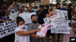A group of people demonstrate against the government during a curfew, Apr. 3, 2022, in Colombo, Sri Lanka. (Eranga Jayawardena/AP)