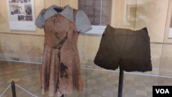 សម្លៀកបំពាក់​ជនរងគ្រោះ​ដែល​ត្រូវ​បាន​ដាក់​តាំង​នៅ​ក្នុង​ពិព័រណ៍ «ការ​ចងចាំ​ជនរងគ្រោះ​តាមរយៈ​សម្លៀកបំពាក់» នៅ​សារមន្ទីរ​ប្រល័យ​ពូជសាសន៍​ទួលស្លែង ក្នុង​រាជធានី​ភ្នំពេញ កាល​ពី​ថ្ងៃ​ទី៧ ខែ​មីនា ឆ្នាំ​២០២២។ (ណឹម សុភ័ក្រ្តបញ្ញា/វីអូអេ)