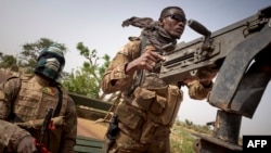 FILE - Soldiers of the Malian army are seen during a patrol on a road between Mopti and Djenne, in central Mali, Feb. 28, 2020.