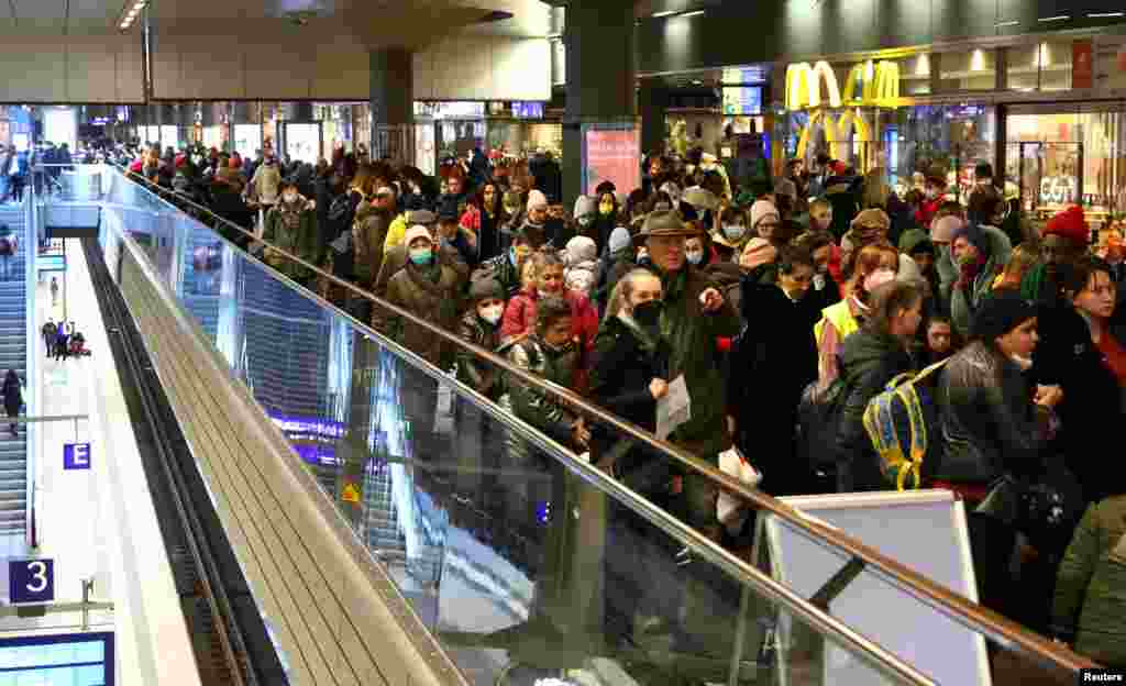 People queue after a train from Poland arrived with people fleeing Ukraine following Russia&#39;s invasion, at the central train station in Berlin, Germany, March 10, 2022. 