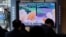  FILE - People watch a TV showing a file image of North Korea's missile launch during a news program at the Seoul Railway Station in Seoul, South Korea, March 5, 2022. 