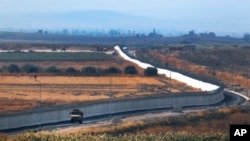 FILE - A Turkish forces vehicle patrols the border with Syria in Akcakale, Sanliurfa province, southeastern Turkey, Oct. 22, 2019.