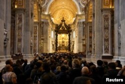 Faithful pay homage to former Pope Benedict, as his body lies in state at St. Peter's Basilica, at the Vatican, Jan. 3, 2023.