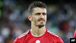FILE - Iran's Voria Ghafouri listens to the national anthem before an international friendly soccer match between Iran and Uzbekistan at Azadi Stadium in Tehran, May 19, 2018.