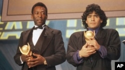 FILE - In this March 1987 photo, Pele, left, and Diego Maradona, hold trophies during an awards ceremony in Italy.