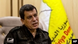 Syrian-Kurdish commander, Mazloum Abdi, of the U.S.-backed Syrian Democratic Forces, speaks during a news conference in Hassakeh, Syria, Saturday, Nov. 26, 2022. 