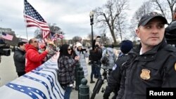 FILE - A U.S. Supreme Court police officer stands on alert in Washington on Jan. 6, 2021.