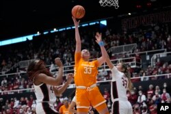 FILE - Tennessee guard Marta Suarez (33) shoots between Stanford forward Kiki Iriafen, left, and guard Hannah Jump during the first half of an NCAA college basketball game in Stanford, Calif., Sunday, Dec. 18, 2022. (AP Photo/Godofredo A. Vásquez)