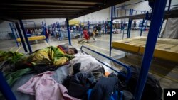 A migrant child sleeps at a government-run shelter in Ciudad Juarez, Mexico on Dec. 18, 2022.
