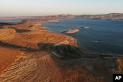 Water levels are low at San Luis Reservoir, which stores irrigation water for San Joaquin Valley farms, in Gustine, Calif., Sept. 14, 2022. (AP Photo/Terry Chea, File)