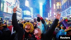 FILE - People celebrate as confetti flies around the countdown clock during the first public New Year's event at Times Square, in the Manhattan borough of New York City, Jan. 1, 2023. (REUTERS/Andrew Kelly)