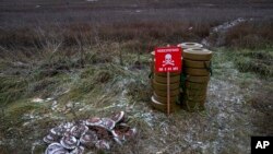 FILE - Anti-tank mines are seen in the field near the recently liberated village of Pravdyne, Kherson region, Ukraine, Dec. 6, 2022. 