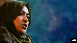 Batool Haidari, 37, talks during an interview with The Associated Press on a train taking her from her home on the outskirts of Rome, to the capital's center, Dec. 5, 2022. 