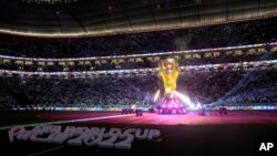 Trofi Piala Dunia diterangi dengan cahaya lampu, sebelum pertandingan pembukaan grup A antara Qatar melawan Ekuador di Stadion Al Bayt di Al Khor, Minggu 20 November 2022.