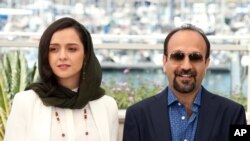 FILE - Actress Taraneh Alidoosti, left, and director Ashgar Farhadi pose for photographers at the Cannes Film Festival on May 21, 2016. Their film, "The Salesman," showed at the festival and won an Oscar for Best Foreign Language film in 2017. 