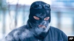 Charles Zajicek uses a power sweeper to clear snow off the sidewalk Dec. 22, 2022, in downtown Minneapolis. 