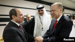 Presiden Turki Recep Tayyip Erdogan (kanan) berjabat tangan dengan Presiden Mesir Abdel Fattah el-Sisi dalam pertemuan pada Piala Dunia di Doha, Qatar 20 November 2022. 