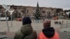 Local citizens walk near a Christmas tree decorated for Orthodox Christmas and the New Year festivities in Mariupol, in Russian-controlled Donetsk region, eastern Ukraine, Jan. 5, 2023.