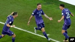 Argentina's Alexis Mac Allister, center, celebrates after scoring his side's opening goal during the World Cup group C soccer match between Poland and Argentina at the Stadium 974 in Doha, Qatar, Nov. 30, 2022.