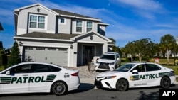 Security personnel stand outside the rented house of the former Brazilian president Jair Bolsonaro at the Encore Resort near Orlando, Fla., on Jan. 10, 2023.