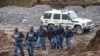 South African police investigate at the scene where more than 20 bodies, suspected of being illegal miners, were found near an active mine in Krugersdorp, South Africa, Nov. 3, 2022.