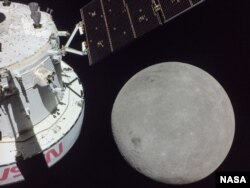 A portion of the far side of the Moon looms large just beyond the Orion spacecraft in this image taken Monday, Nov. 21