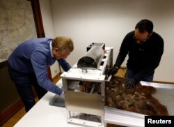 Patrick Janssen, salah satu pendiri organisasi Dung Dung, dan Thomas Petry, produser, membuat ubin dari rambut manusia daur ulang yang digunakan untuk menyerap bahan kimia pencemar dalam air, di Waremme, Belgia 8 Desember 2022. (REUTERS/Yves Herman)