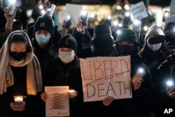 FILE - Protesters gather near the Chinese consulate to stand in solidarity with their counterparts around the world demonstrating against China's severe anti-virus restrictions, in New York, Nov. 29, 2022.