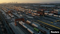 FILE - Gantry cranes, shipping containers, and freight railway trains are seen at the Union Pacific Los Angeles (UPLA) Intermodal Facility rail yard in Commerce, California, Sept. 15, 2022.