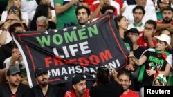 Iran fans hold a banner reading 'Woman life freedom' inside the stadium during the Group B match between England and Iran at Khalifa International Stadium, Doha, Qatar, on Nov. 21, 2022.