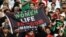 Iran fans hold a banner reading 'Woman life freedom' inside the stadium during the Group B match between England and Iran at Khalifa International Stadium, Doha, Qatar, on Nov. 21, 2022.
