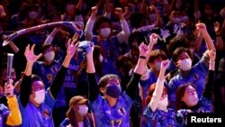 FILE- Japanese soccer fans react after Japan won a FIFA World Cup Qatar 2022 match with Germany, at a public viewing event in Tokyo, Japan, Nov. 23, 2022. 