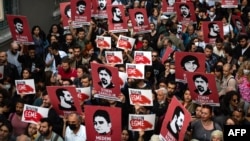 FILE - Protesters hold placards and shout slogans in Istanbul on April 26, 2022 during a rally in support of civil society leader Osman Kavala.
