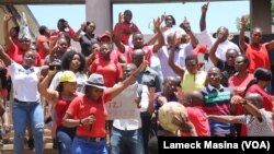 Workers strike outside the High Court in Blantyre, Malawi, Dec. 13, 2022. The nationwide strike is aimed at forcing the government to improve working conditions. 