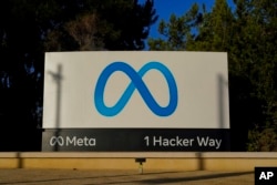 FILE - Meta's logo can be seen on a sign at the company's headquarters in Menlo Park, California, on Nov. 9, 2022.