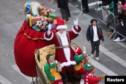Santa Claus waves to the crowd during the 96th Macy's Thanksgiving Day Parade in New York, Nov. 24, 2022.