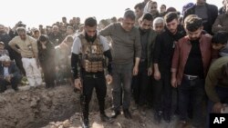 FILE - Syrian Kurds attend a funeral of people killed in Turkish airstrikes in the village of Al Malikiyah, northern Syria, Nov. 21, 2022. Turkey said the airstrikes were aimed at Kurdish militants whom Ankara blamed for a deadly bombing in Istanbul.